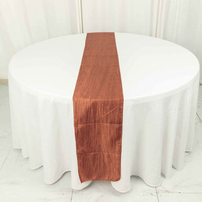 Copper satin table runner on a round white table.