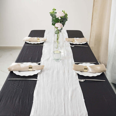 Elegant dinner table setting with floral centerpiece and decorative napkins.