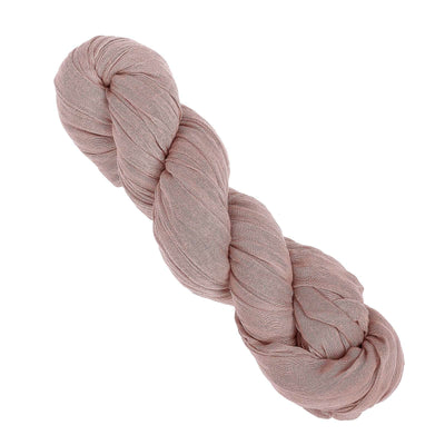 Braided soft pink fabric yarn on a white background