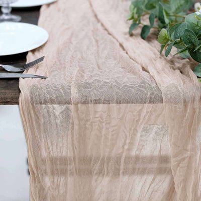 Light beige textured table runner draped elegantly over a wooden table.