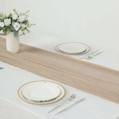 Elegant table setting with plates, cutlery, and a floral centerpiece.