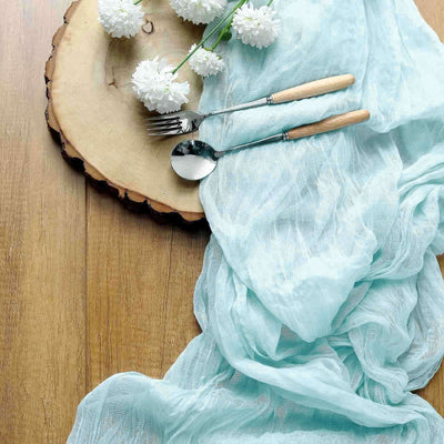 Table setting with cutlery and flowers on a wooden surface.