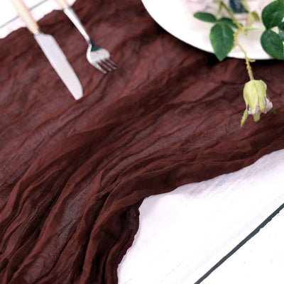 Brown crinkled table runner on a rustic white table setting