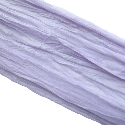 Light purple crinkled fabric draped elegantly on a white background