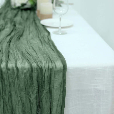 Textured green table runner draped over a white tablecloth.