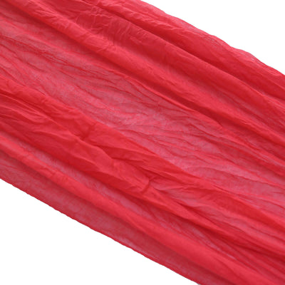 Crinkled red fabric draped elegantly on a white background.