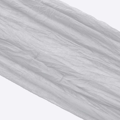 Textured white fabric draped elegantly, showcasing its soft, crinkled surface.