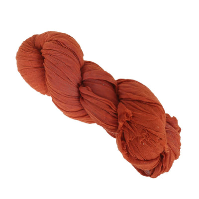 Rust-colored lightweight fabric yarn bundle on a white background