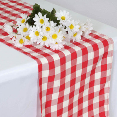 Red and white checkered table runner with white daisies on top.