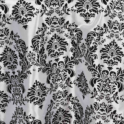 Black and silver damask fabric with intricate floral patterns.