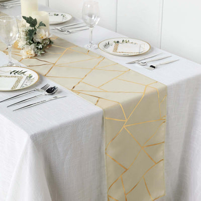 Elegant gold geometric table runner on a white table setting with dinnerware.
