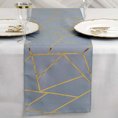 Elegant blue table runner with gold geometric pattern, styled for a dining table setting.