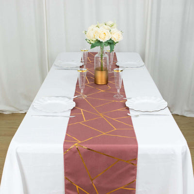 Elegant table setting with a geometric runner and floral centerpiece.