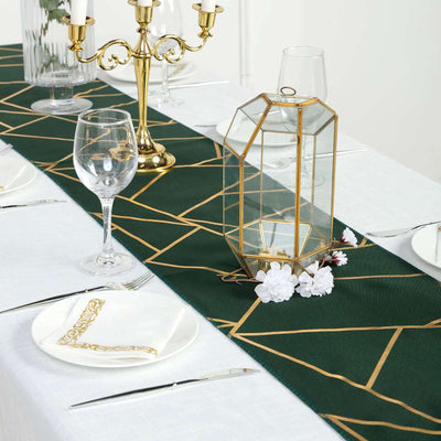 Elegant green table runner with gold geometric design on a dining table setting.