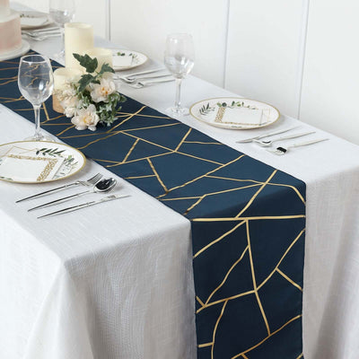 Navy table runner with gold geometric pattern on a white table setting