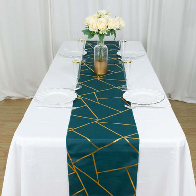 Decorative green table runner with gold geometric design on a set dining table.