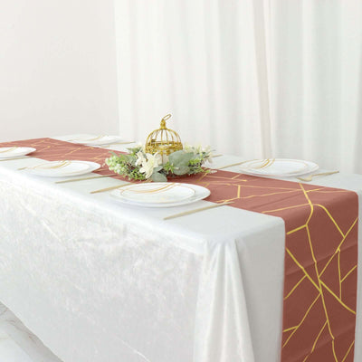 Elegant table setting with a gold-accented runner and decorative centerpiece.