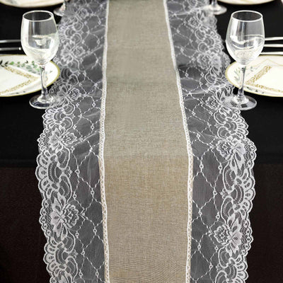 Lace table runner on a black table setting with elegant dinnerware.