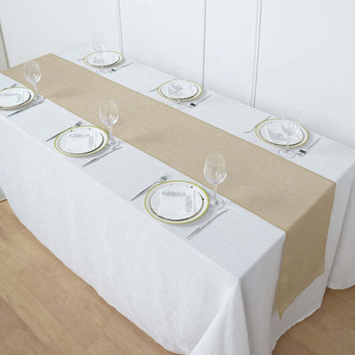 Elegant table setting with a golden runner and white tablecloth.