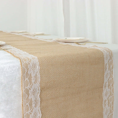 Natural burlap table runner with lace trim on a dining table.