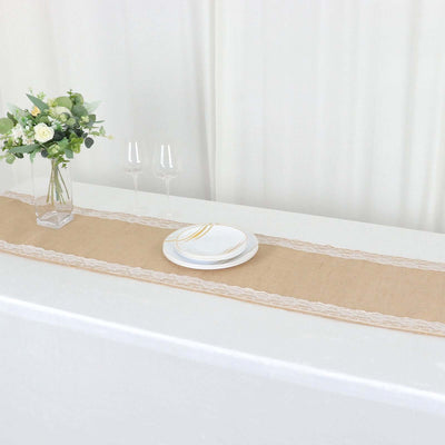 Burlap table runner with lace trim, set with plates and glasses on a table.