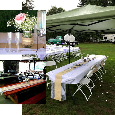 Outdoor wedding setup with tables, decorations, and tent.