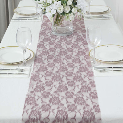 Lace table runner on an elegantly set dining table with floral centerpiece.
