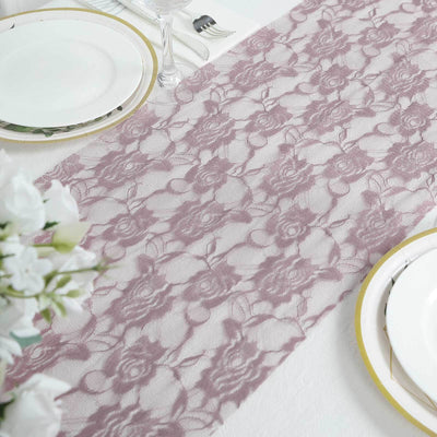 Lace table runner in mauve color on a dining table setting.