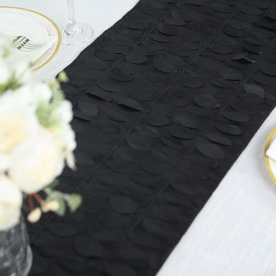 Black table runner with textured circular embellishments on a dining table.