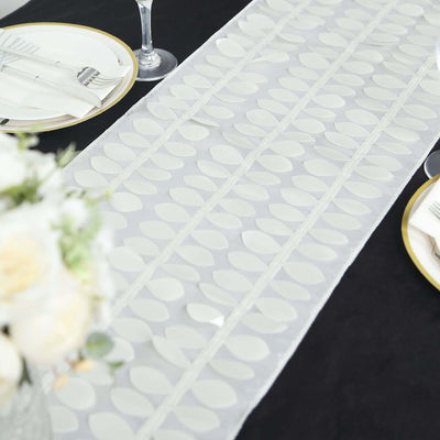 Elegant leaf-patterned table runner for dining decor.