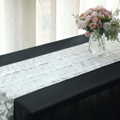 Elegant table runner with decorative petals on a black tablecloth.