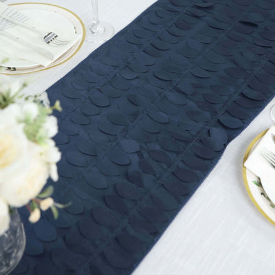 Navy blue table runner with textured leaf pattern on a dining table.