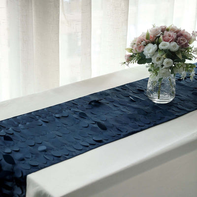 Navy blue table runner with textured design on a table with a floral arrangement.