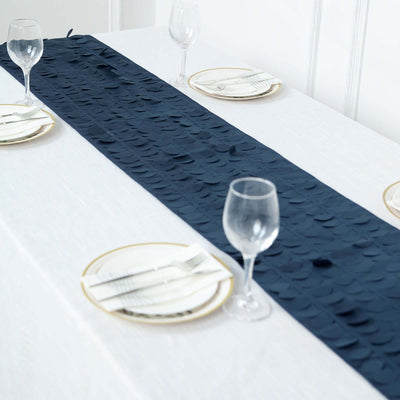 Navy table runner on a white table setting with elegant plates and glasses.