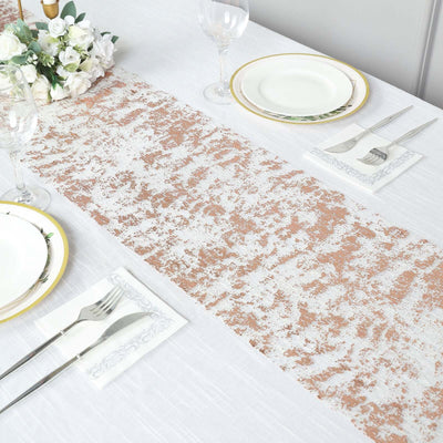 Elegant table setting with a rose gold runner and fine dining accessories.