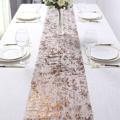 Elegant table runner with gold accents on a white table setting.