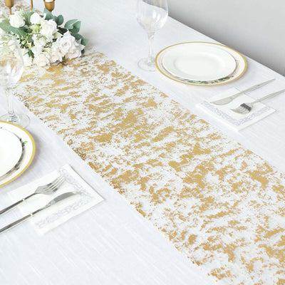 Elegant gold and white table runner on a dining table setting.