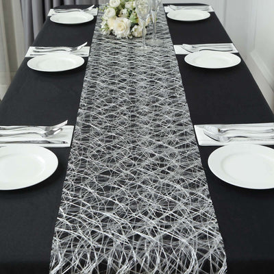 Elegant silver table runner on a black dining table set for a meal.