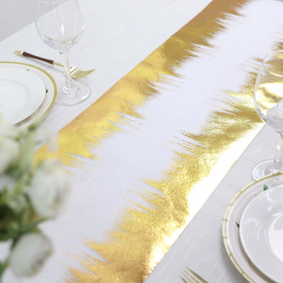 Gold and white table runner on a dining table setting.