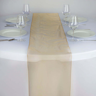 Elegant beige table runner on a dining table set for a meal.