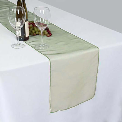 Elegant table runner in soft green with decorative trim, perfect for dining setups.