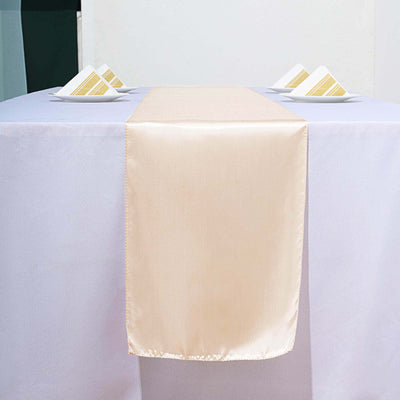 Elegant beige table runner on a light purple tablecloth with decorative napkins.