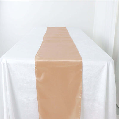 Beige satin table runner on a white tablecloth