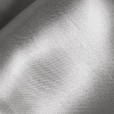 Silky silver fabric texture close-up showing smooth sheen and fine weave.