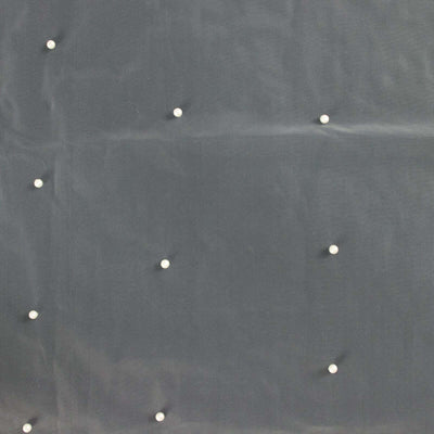 Textured dark fabric with decorative pearls evenly spaced.