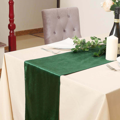 Green velvet table runner on a beige table with decorative elements.