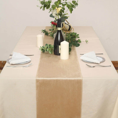 Elegant table setting with candles and greenery for a sophisticated dining experience.