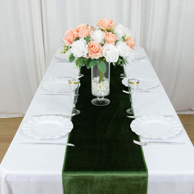 Elegant table setting with floral centerpiece and decorative plates.