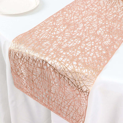 Rose gold lace table runner on white tablecloth.