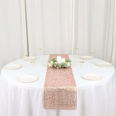 Elegant table setting with a pink runner, candles, and floral accents.